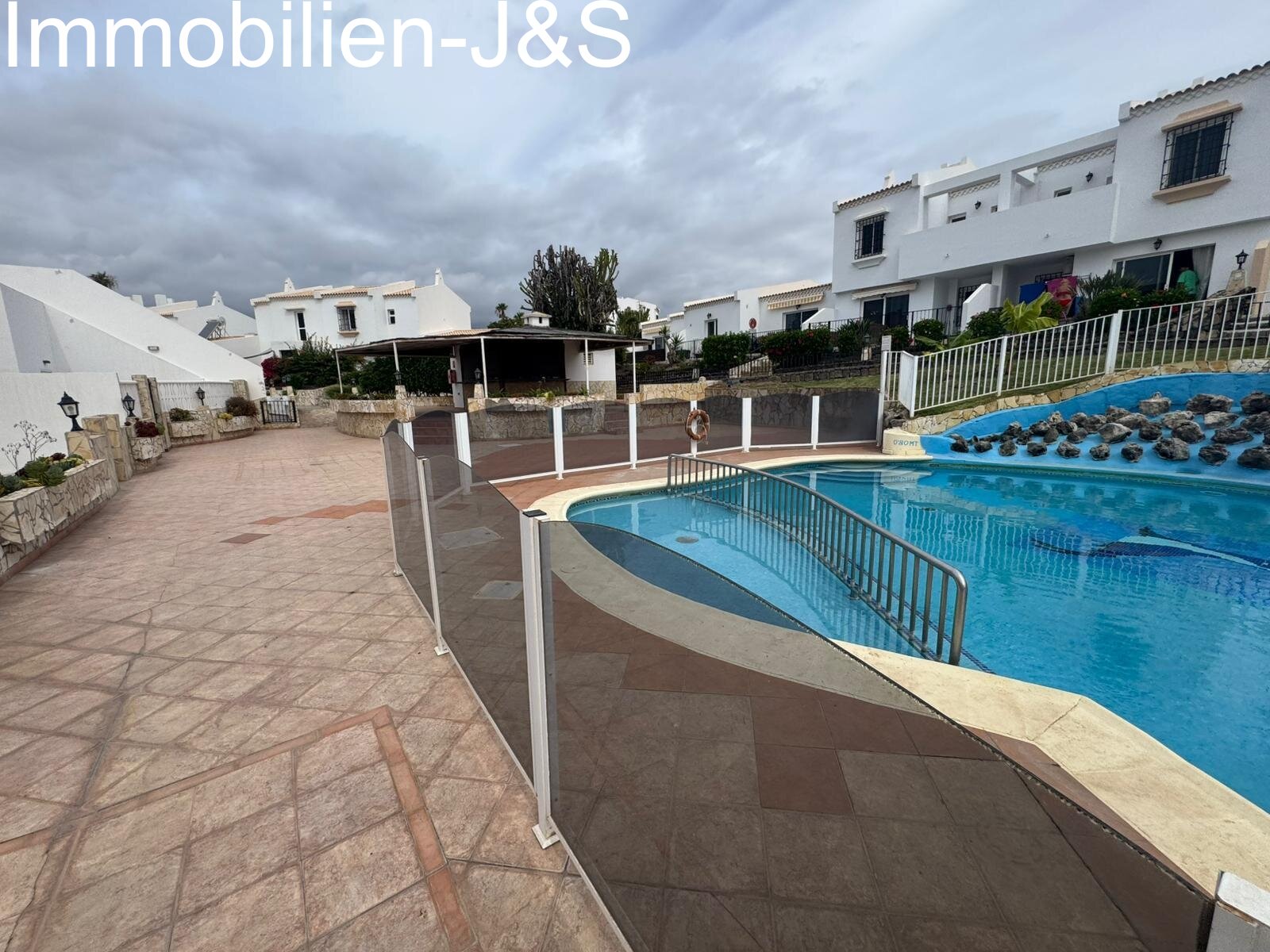 Ein harmonisches Zusammenspiel aus Privatsphäre und Gemeinschaft. Die Immobilie bietet einen charmanten privaten Garten mit Kunstrasen und Terrasse, ideal für entspannte Stunden. Die Anlage selbst überzeugt durch gepflegte Wege, mediterrane Bepflanzung und eine ruhige, sichere Atmosphäre in bester Nachbarschaft.