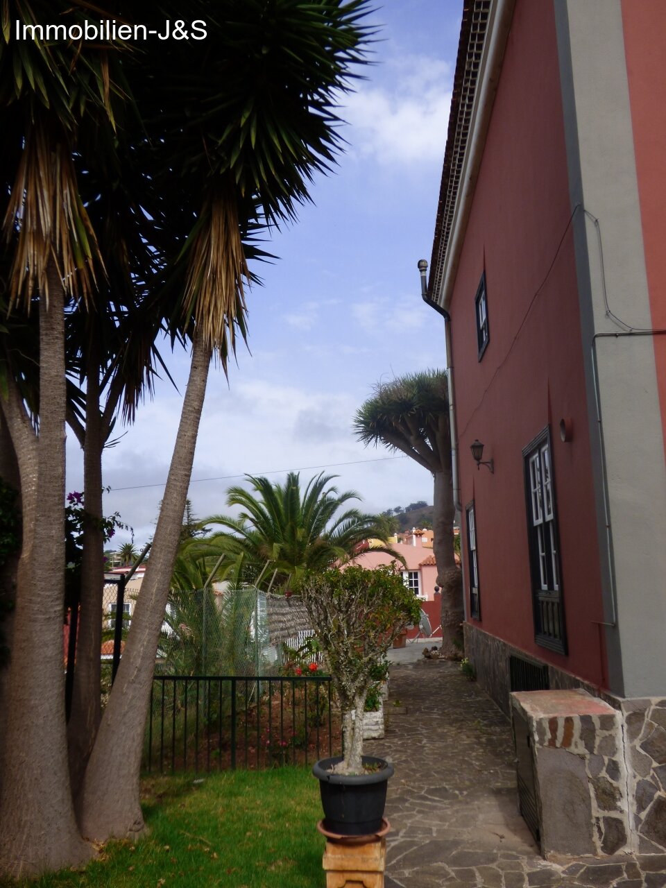 To the side of the house To the side of the house