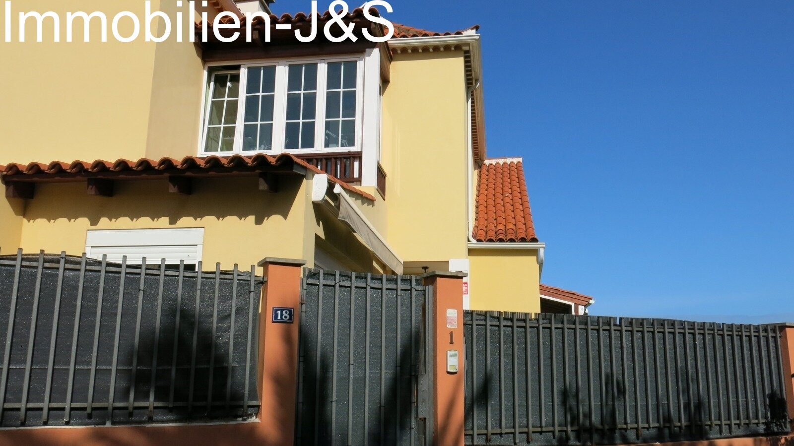 Well-maintained exterior view with secure entrance area