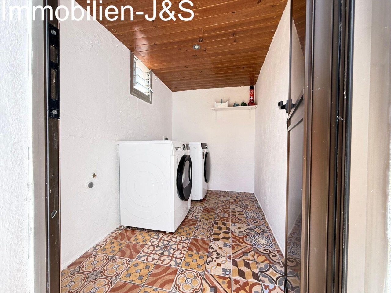 Practical utility room with washing machine and decorative tiles