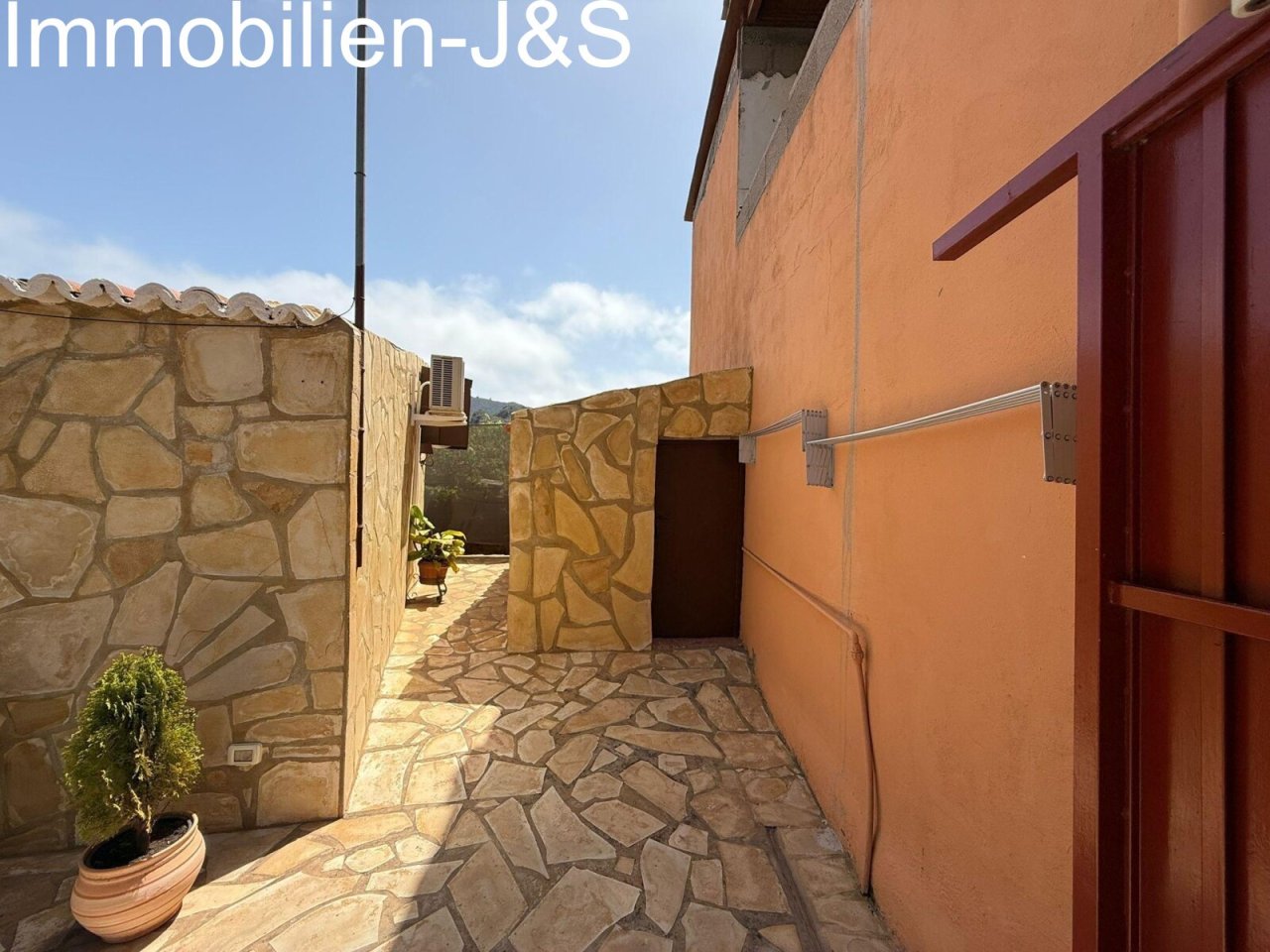 Well-maintained side path with natural stone masonry