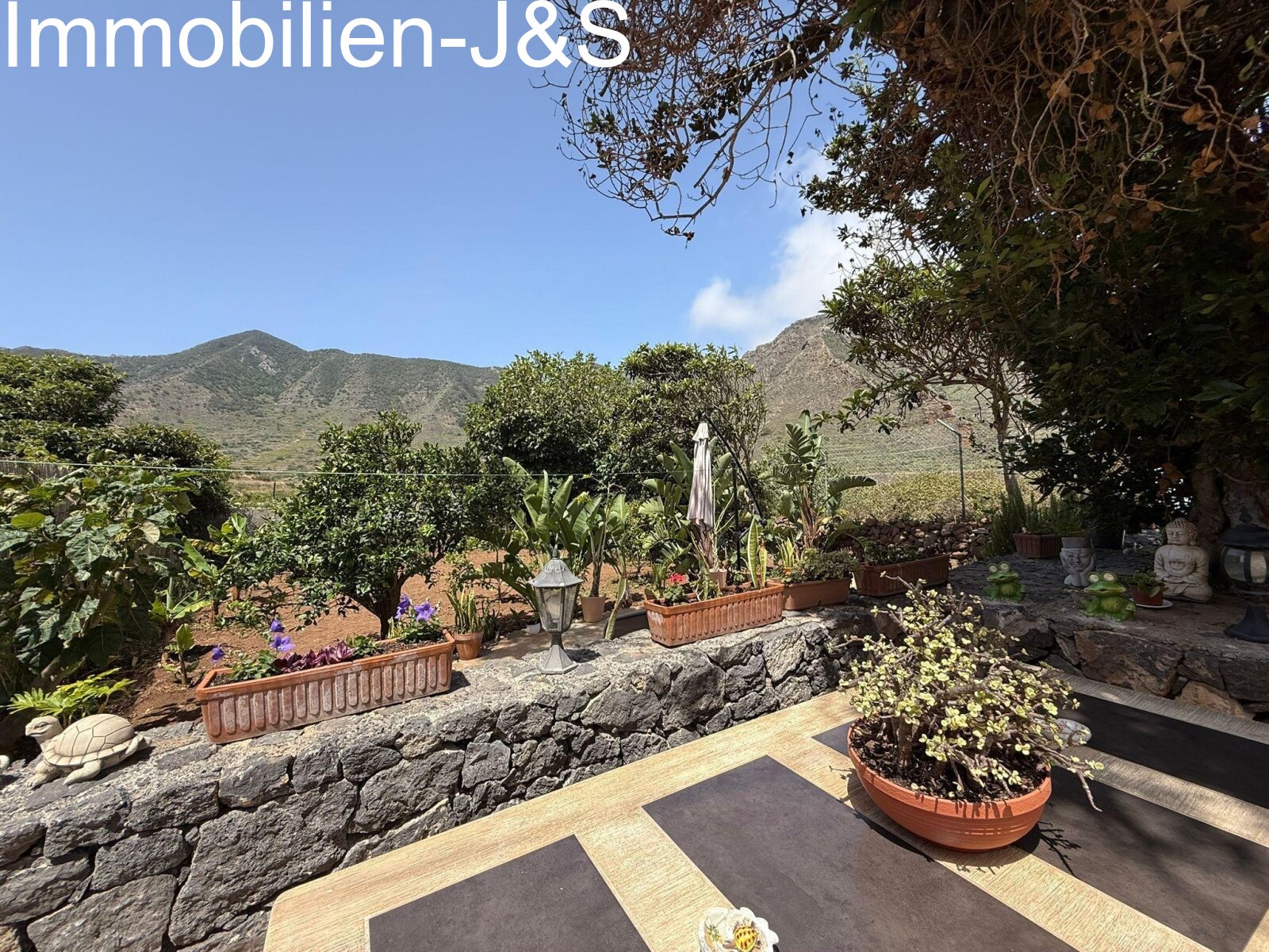 Solid stone table under shady trees with mountain views