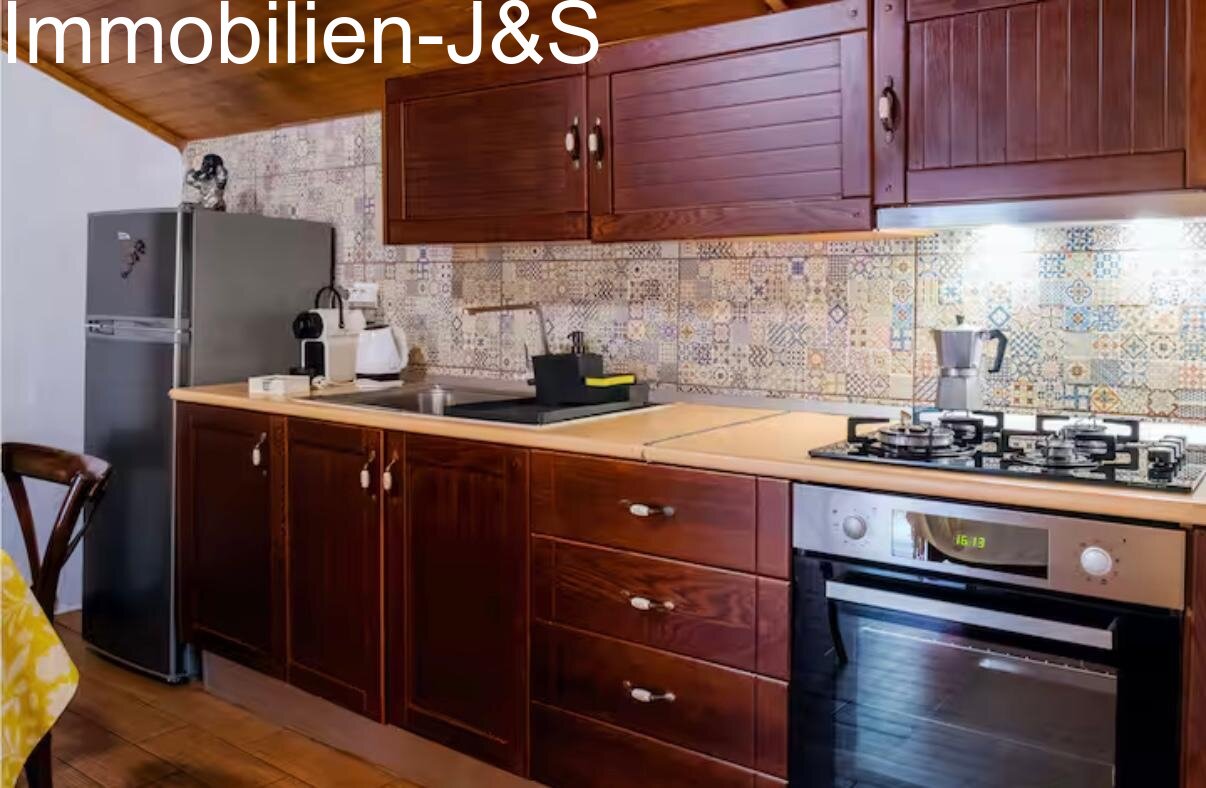 Modern appliances combined with traditional tile patterns.
