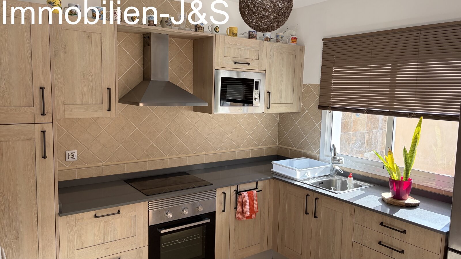 Fully equipped fitted kitchen in light wood finish with modern appliances, including oven, ceramic hob, and microwave. Fully equipped fitted kitchen in light wood finish with modern appliances, including oven, ceramic hob, and microwave.