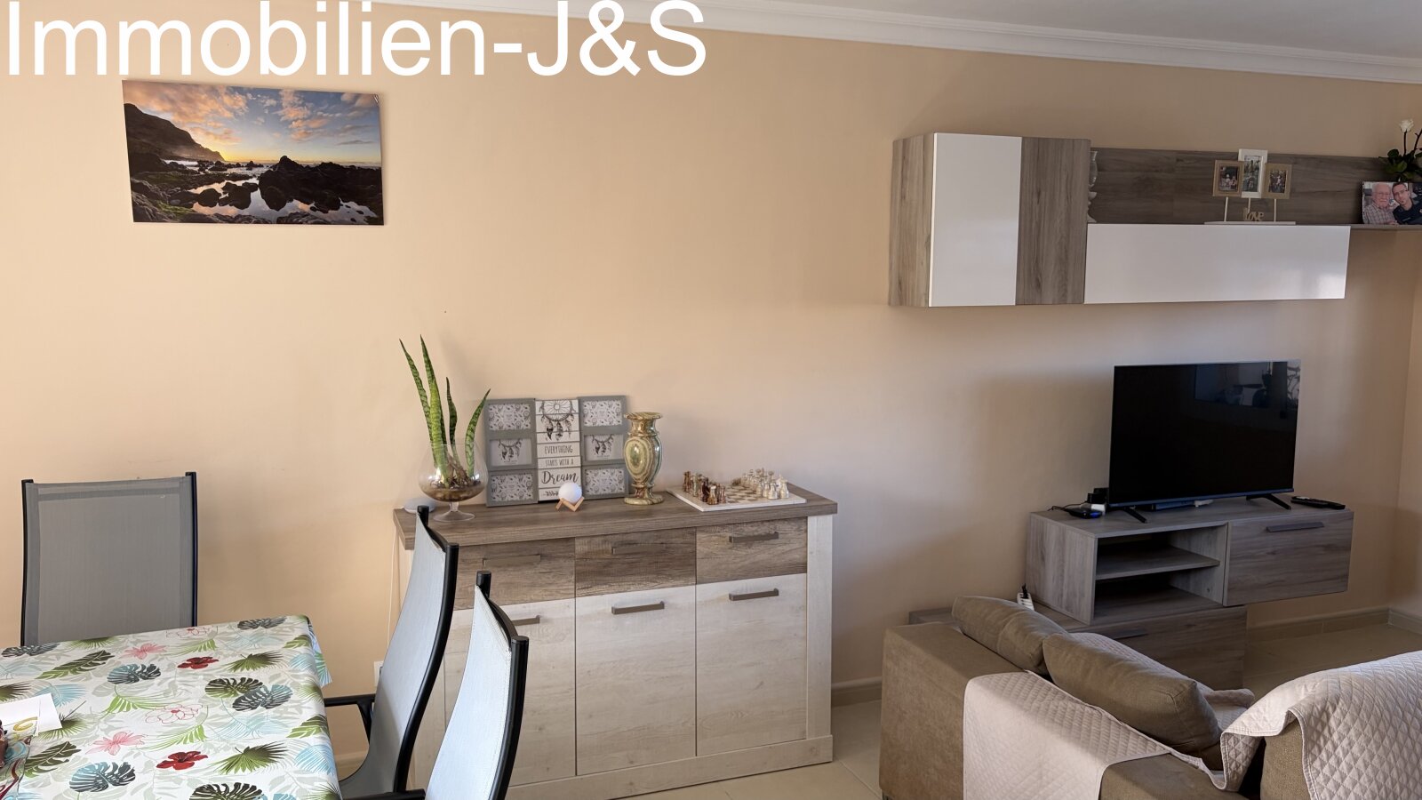 Modern living room with a stylish TV wall unit in wood look and white, featuring large windows for plenty of natural light. Modern living room with a stylish TV wall unit in wood look and white, featuring large windows for plenty of natural light.