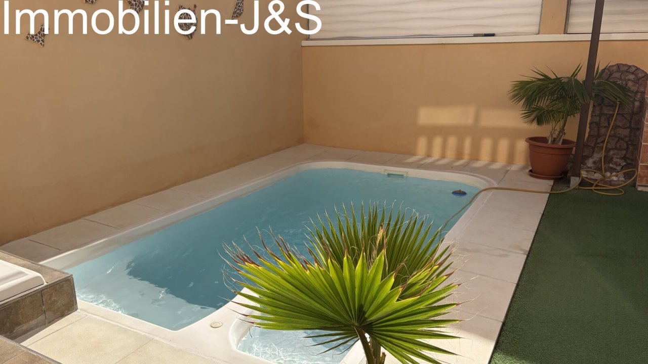 Modern outdoor area featuring a private pool, a stylishly tiled outdoor shower, and decorative wall art depicting the silhouette of the Canary Islands. A comfortable bench provides a perfect spot to relax. Modern outdoor area featuring a private pool, a stylishly tiled outdoor shower, and decorative wall art depicting the silhouette of the Canary Islands. A comfortable bench provides a perfect spot to relax.