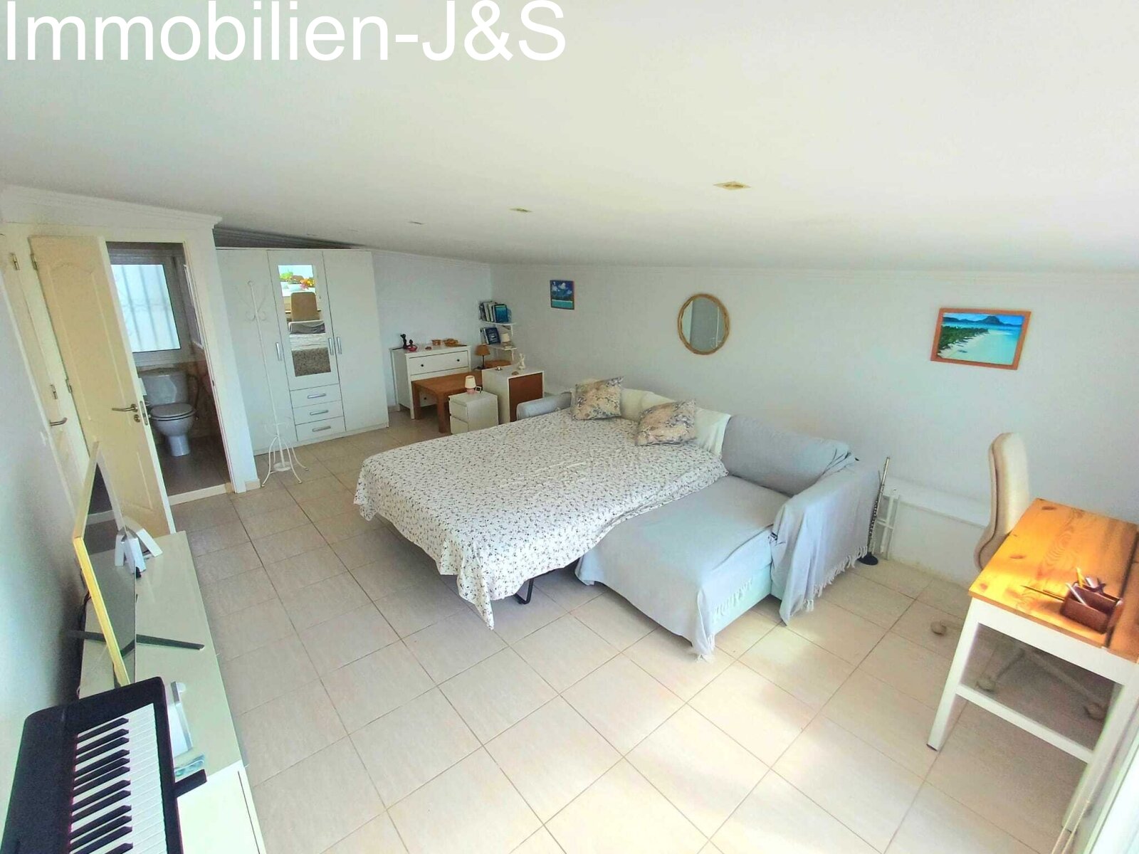 Brightly designed living room featuring a high-quality sofa bed in subtle mint green, providing a comfortable additional sleeping space for guests in no time.